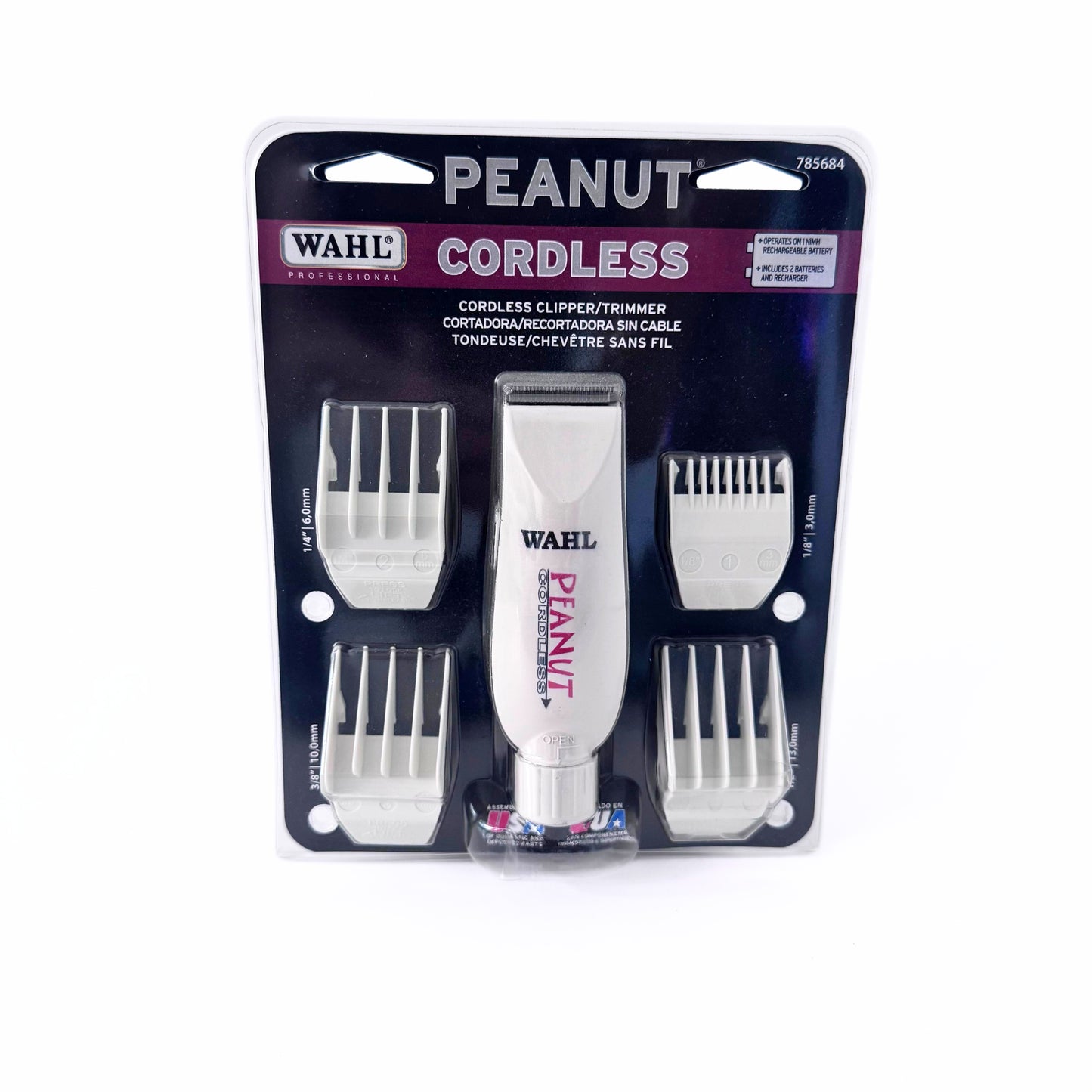 Wahl Pro Peanut Cordless Clipper/Trimmer in white, packaged with multiple guard attachments, displayed on a hanging card.